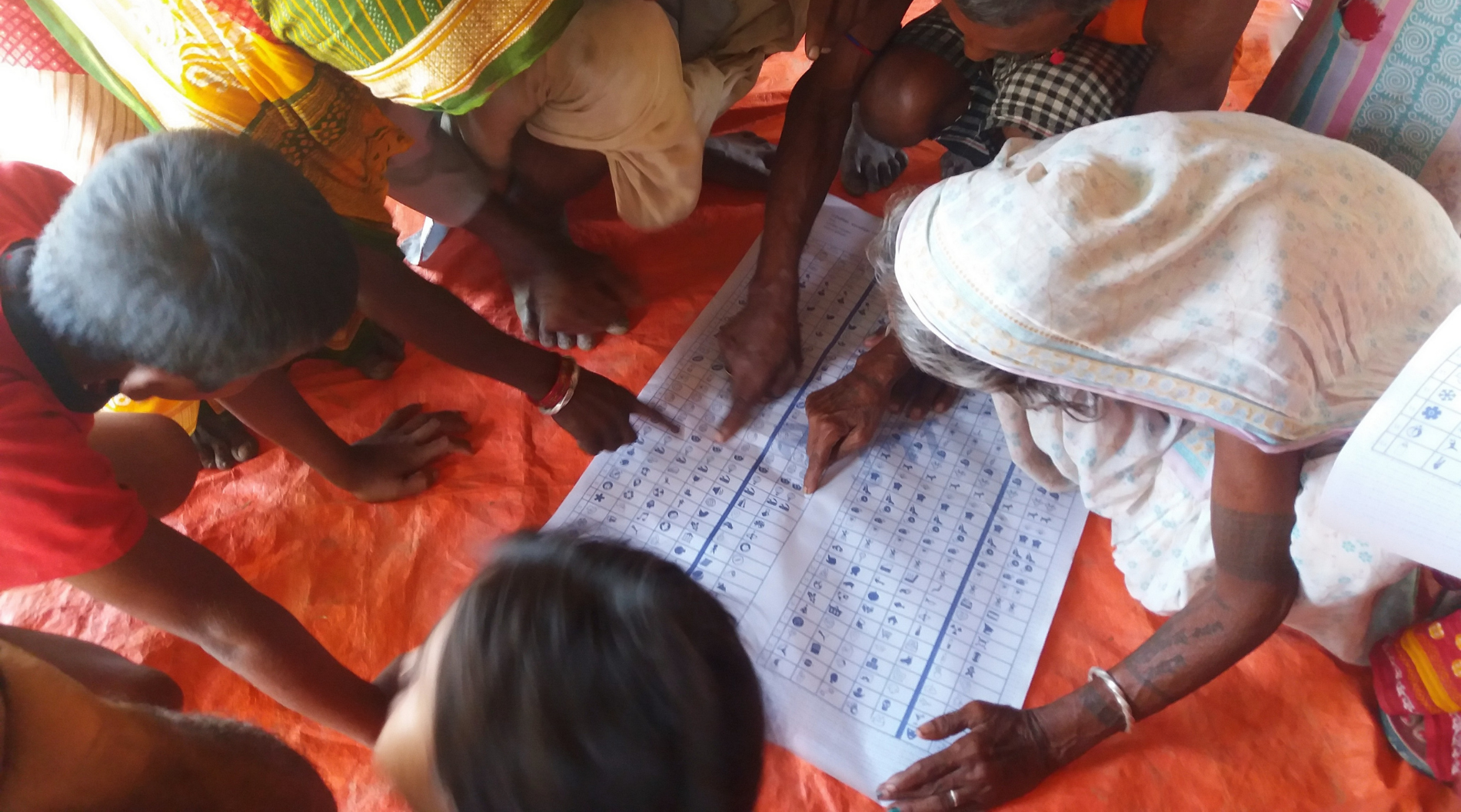 Citizens study a mock ballot while taking part in a mock poll prior to the 2017 local elections in a remote village of Nepal.