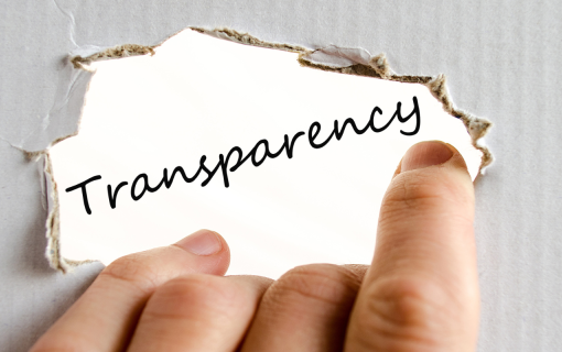 fingers holding label that says transparency with burnt edges on white background