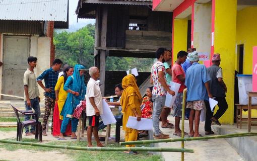 Voters waiting their turn in line to mark the ballot after receiving ballot paper.