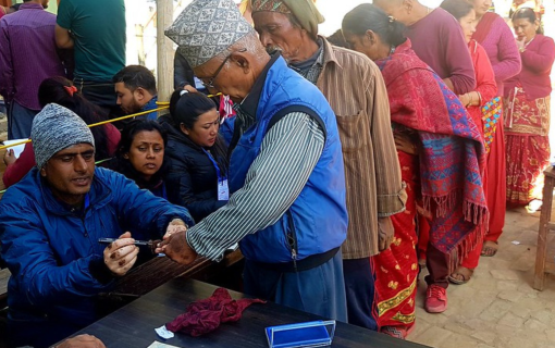 Voters queue to receive their ballots and have their fingers marked with indelible ink in Bhaktapur.