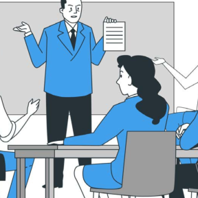 A man presents a piece of paper to a group sitting at a conference table while they make gestures with hands.