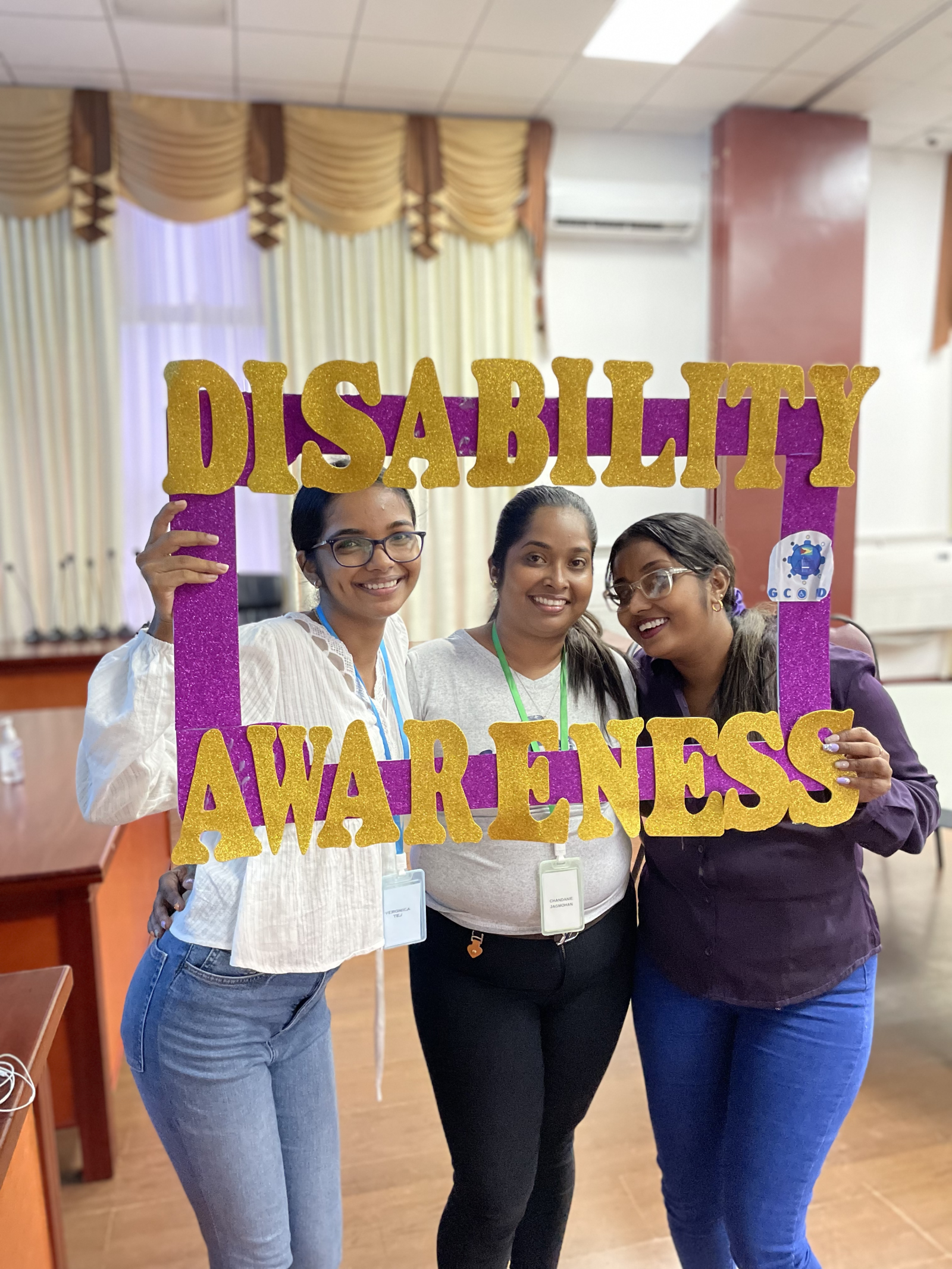 Youth with the conference's selfie frame promoting disability awareness