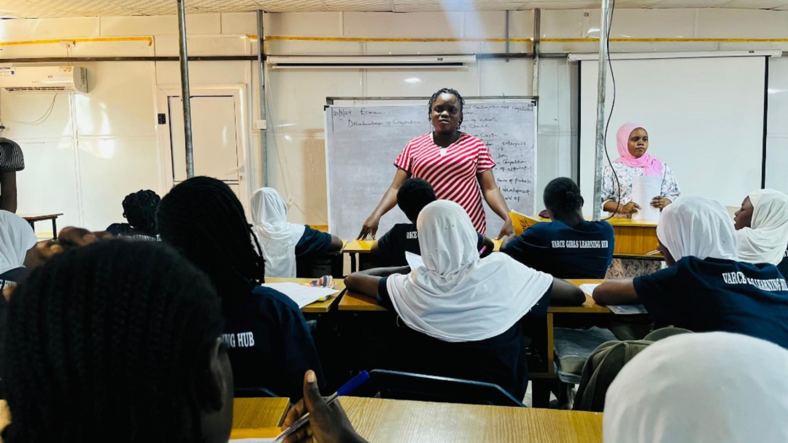 Toyin speaks at lecturn