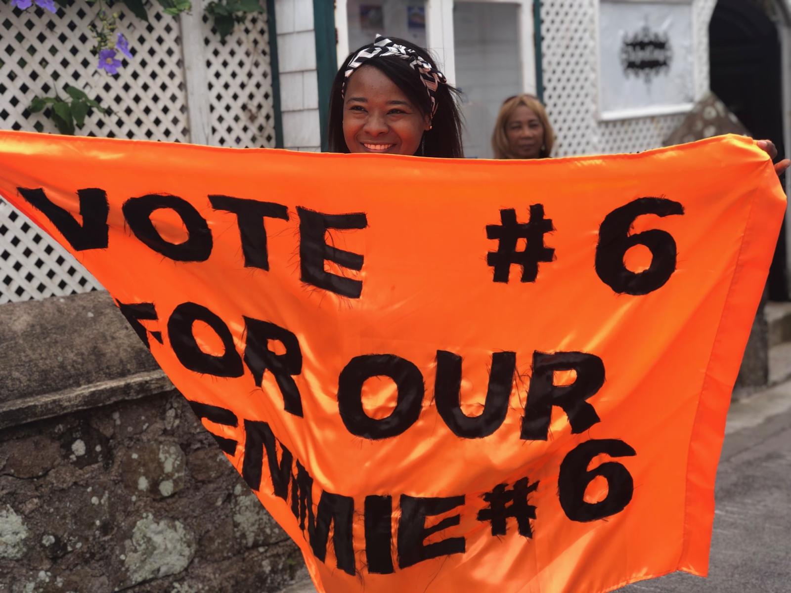Saba citizen holds banner in support of a candidate