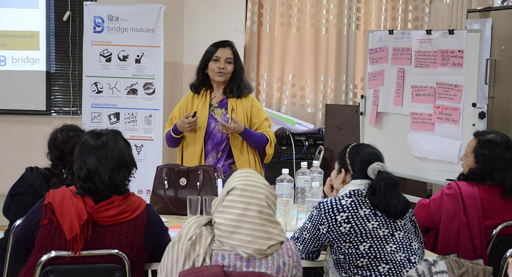 Regmi explains the important role of women leaders to political party members during a BRIDGE workshop on gender and elections.