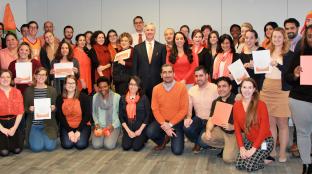 IFES HQ staff group photo in orange against violence against women.