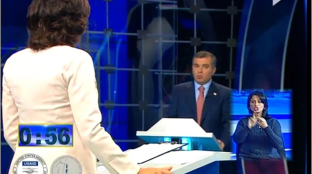 This screenshot shows a televised candidate debate in the Republic of Georgia. A sign language interpreter is visible in the bottom right corner of the screen.