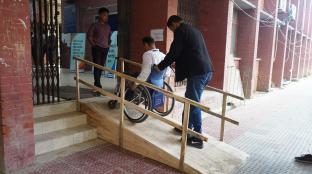People making their way to the mock polling station up a ramp in front of the building.