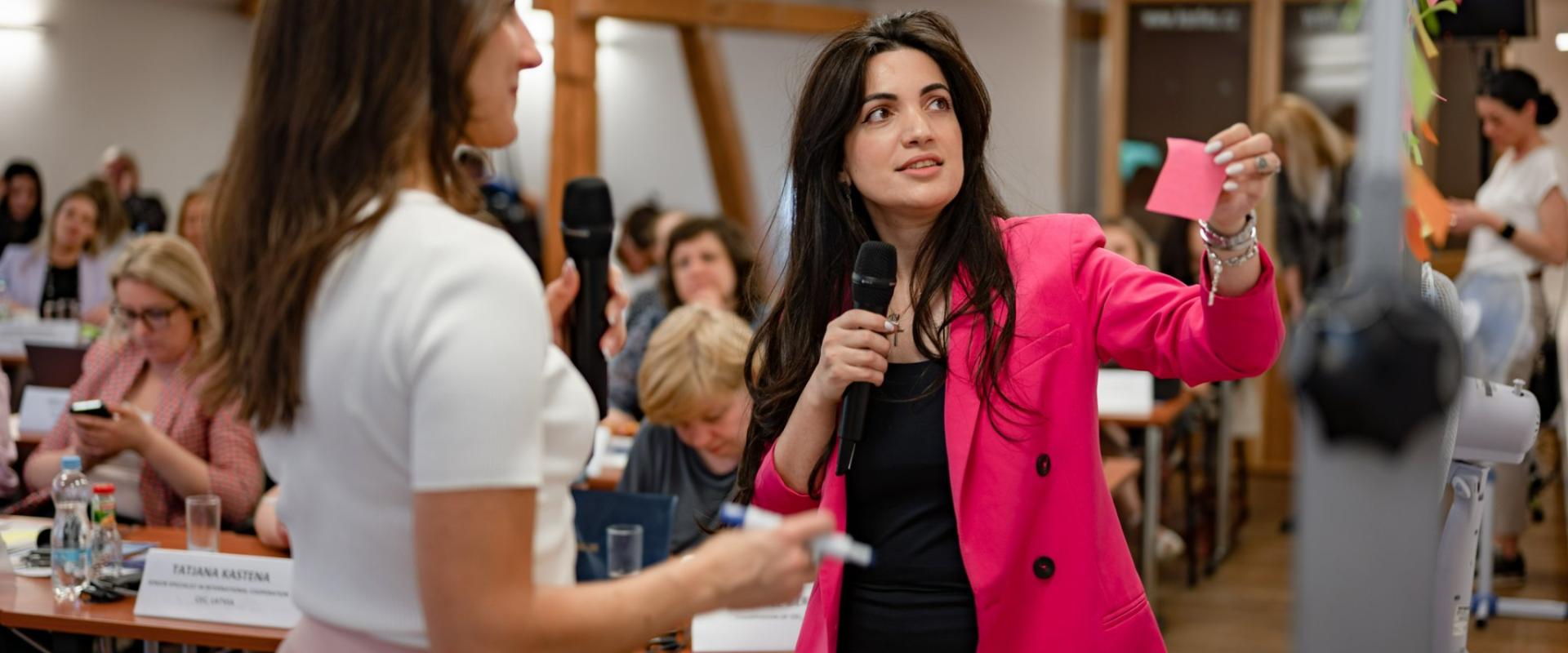 Woman in pink jacket in seminar