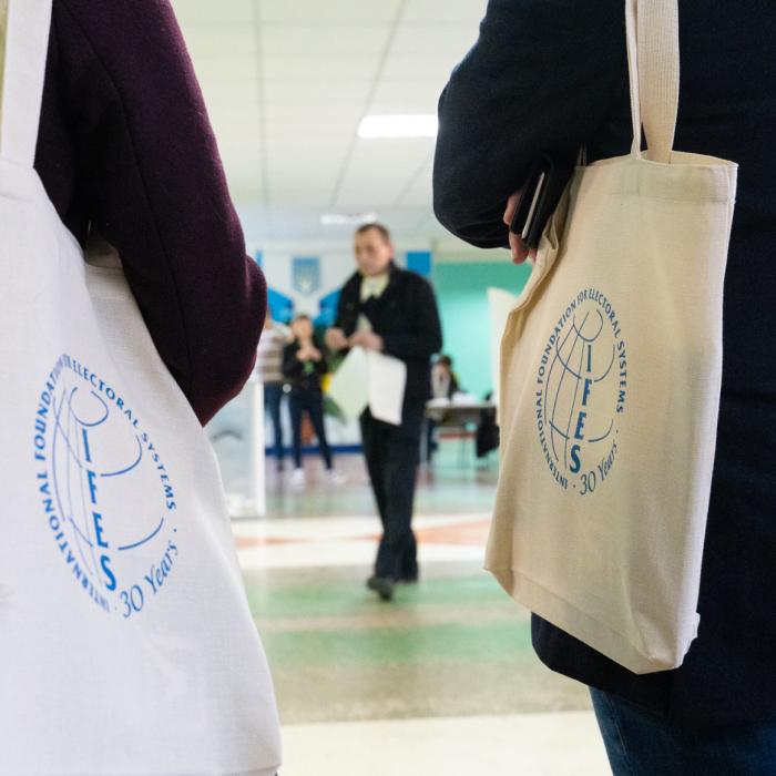 careers-hero.jpg Two people walking with IFES branded tote bags