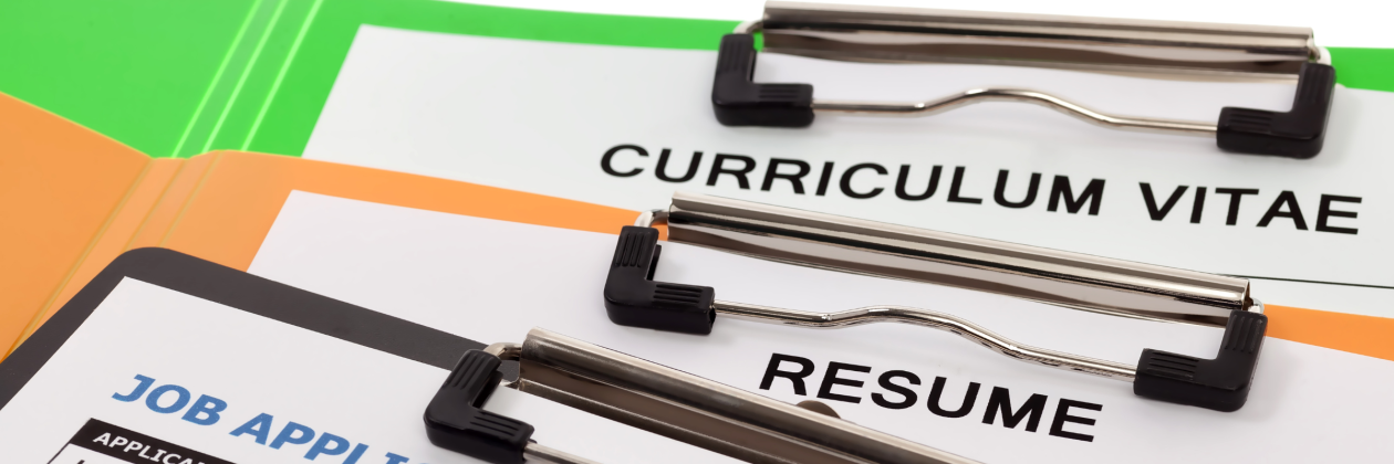 Three clipboards on top of each other read Curriculum Vitae, Resume and Job Application