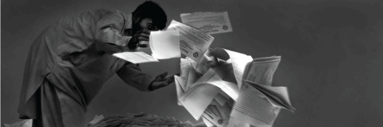 man scattering papers