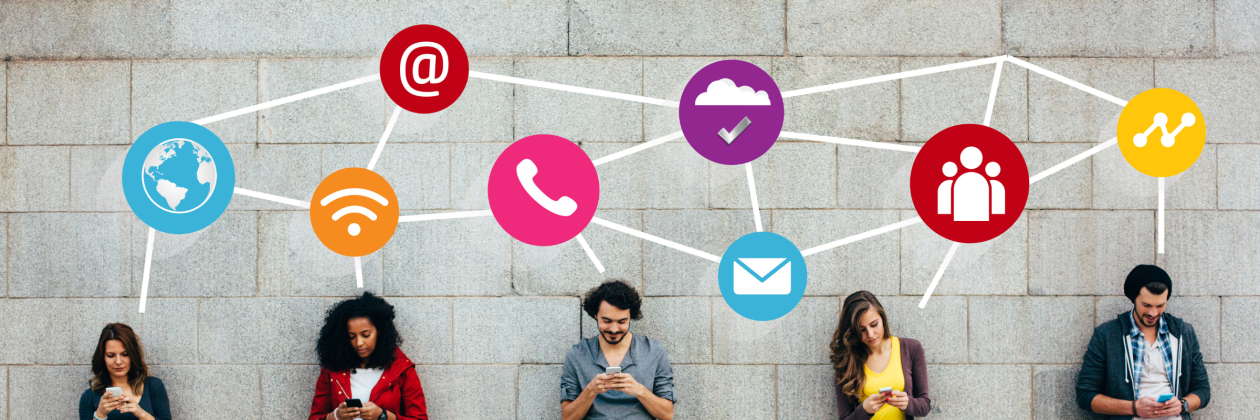 a group of people holding their phones while standing against the wall with digital icons above their heads. 