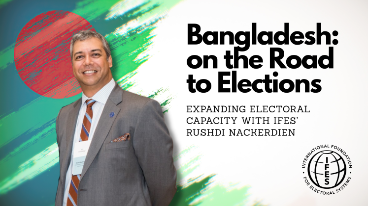 Rushdi Nackerdien standing by the text "Bangladesh: on the Road to Elections"