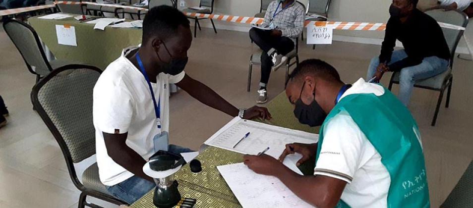 Man signing a ballot.