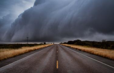 Storm raging over empty road.