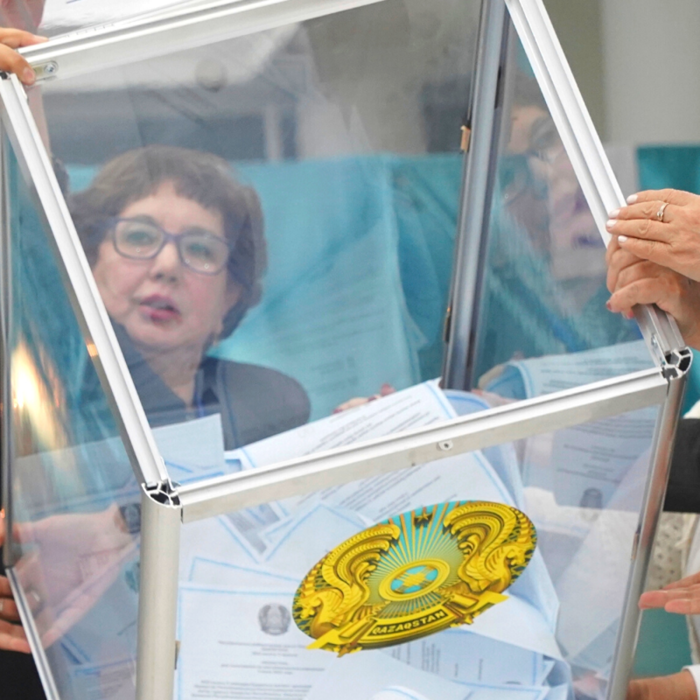 Members of an election commission remove ballots from a box to count them at a polling station after the Nationwide Referendum in Nur-Sultan, Kazakhstan.