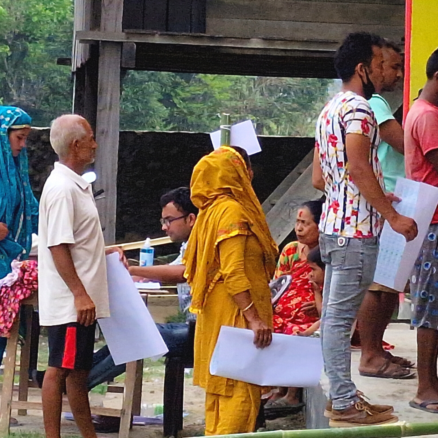 Voters waiting their turn in line to mark the ballot after receiving ballot paper.