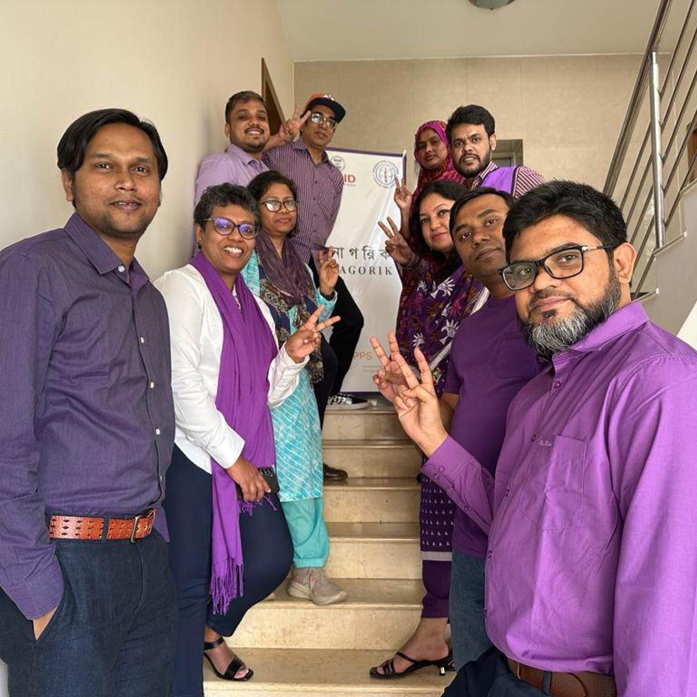 IFES Bangladesh on stairs in purple for IWD 2023