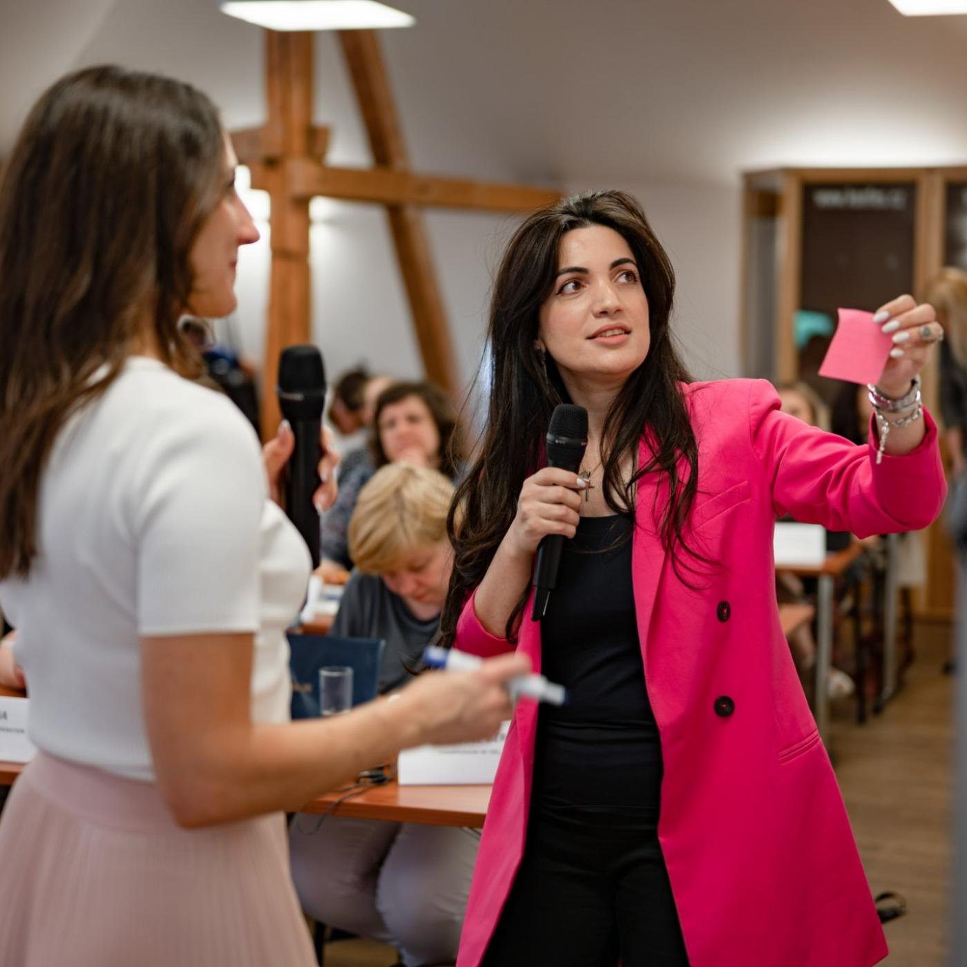 Woman in pink jacket in seminar