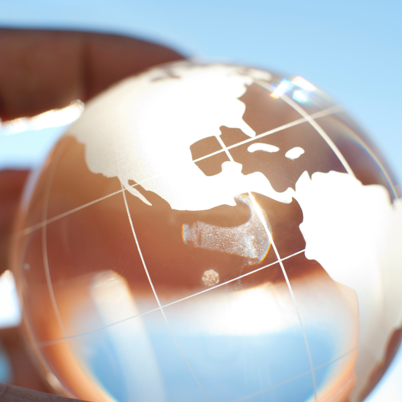 Person holding transparent globe.