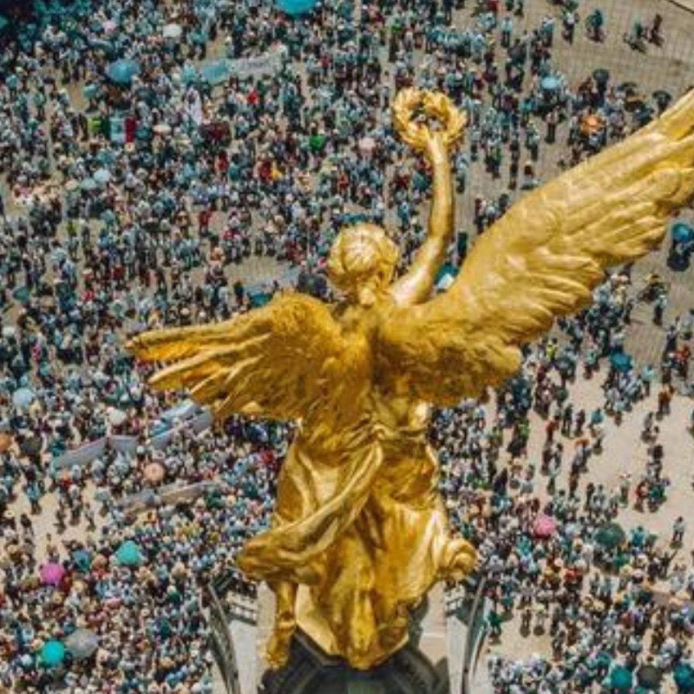 High Angle View Of Crowd Marching On Independence monument in Mexico City.