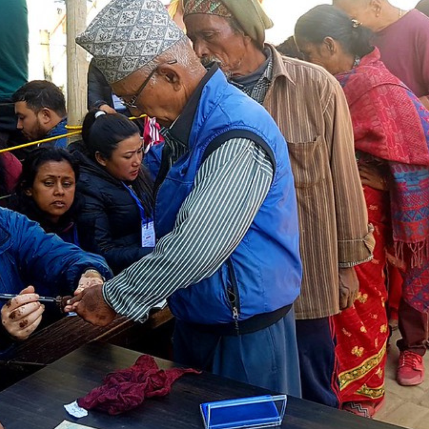 Voters queue to receive their ballots and have their fingers marked with indelible ink in Bhaktapur.