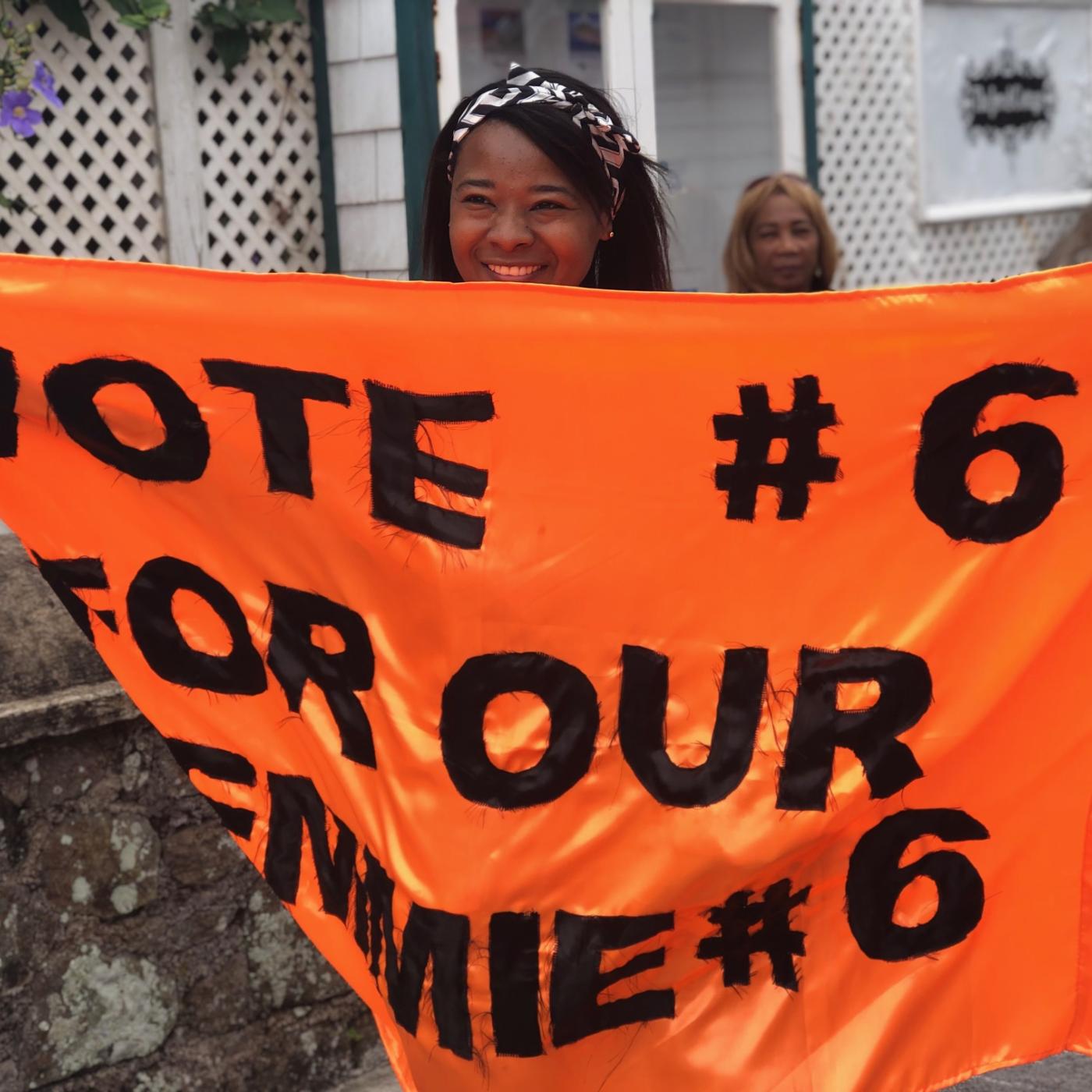 Saba citizen holds banner in support of a candidate